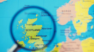 Magnifying glass over map of Scotland
