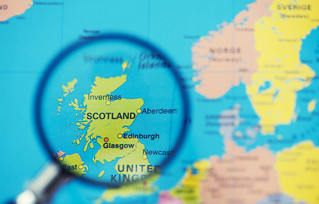 Magnifying glass over map of Scotland