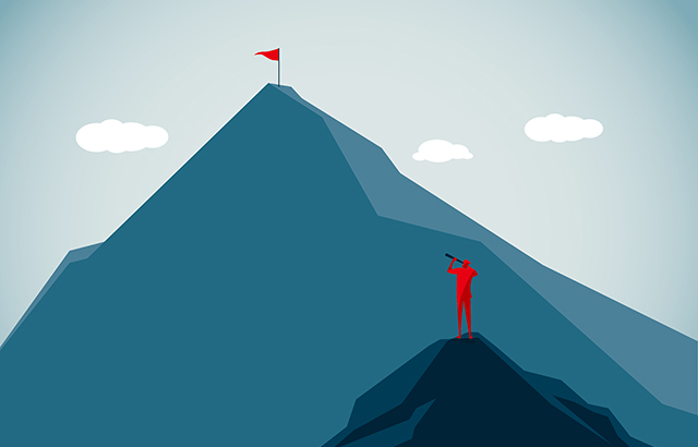 Man look at the peak of a mountain