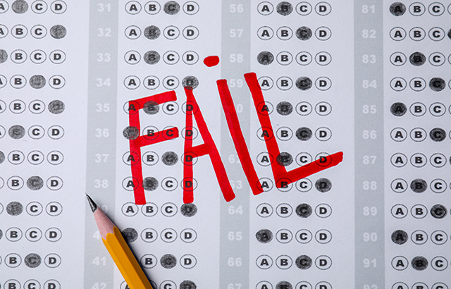 Word Fail written with red marker on answer sheet, flat lay.