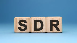 SDR - text concept on wooden cubes with gradient blue background