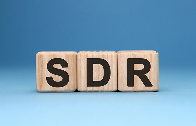 SDR - text concept on wooden cubes with gradient blue background